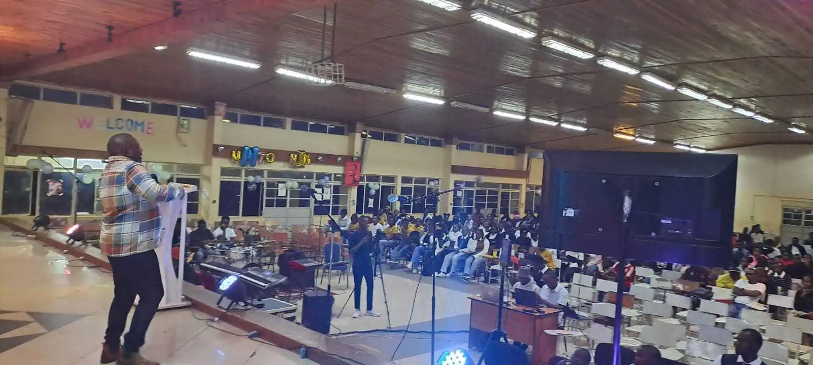 Indoor teaching session with a gathered community