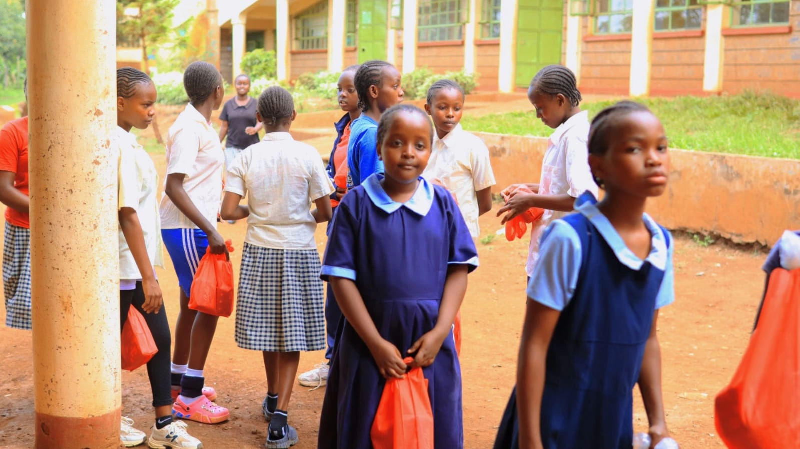 Students gathering in the school courtyard during the menstrual health awareness outreach