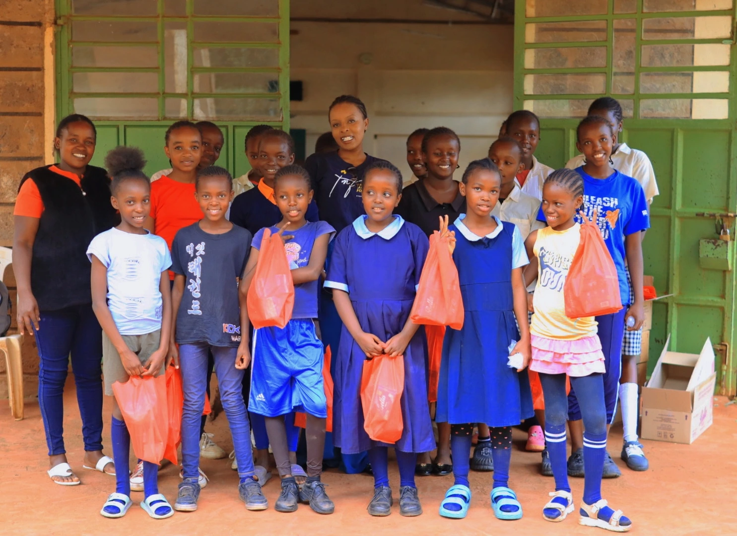 Students smiling while holding their sanitary towel packages